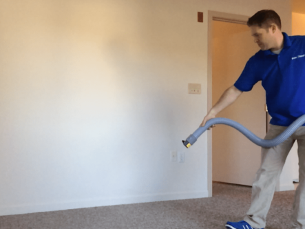 a person is spraying deodorant in a room